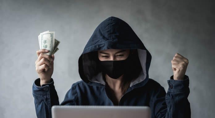 Hacker segurando dinheiro ransomware