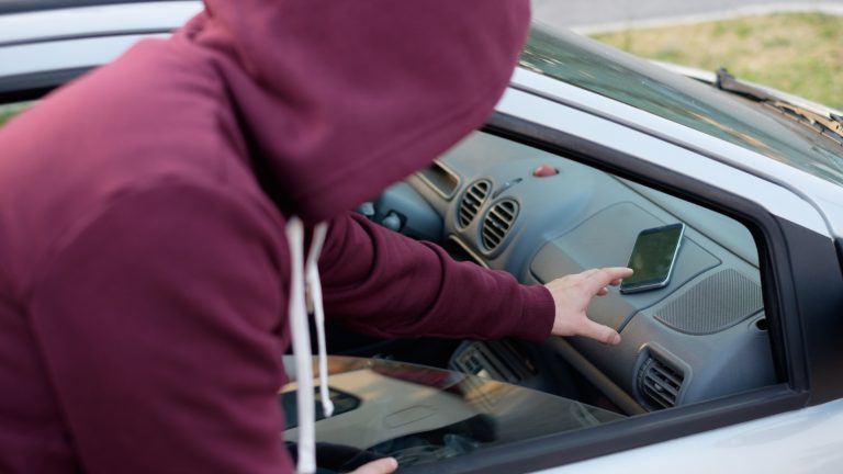 Bandido roubando celular através de janela de carro
