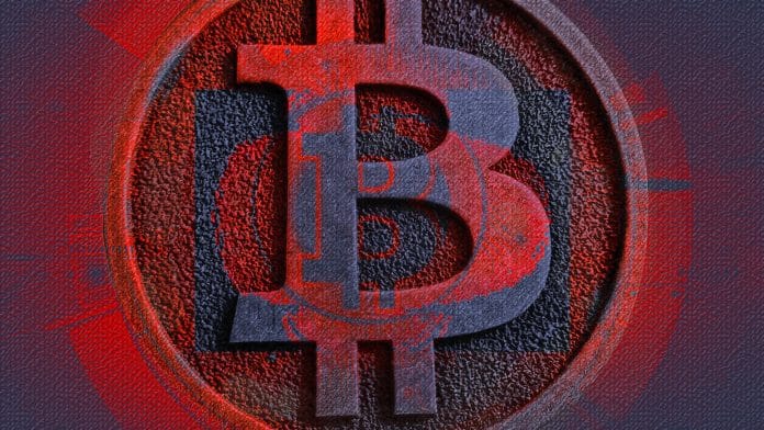 Emblema do Bitcoin de vermelho, sinal de queda no mercado