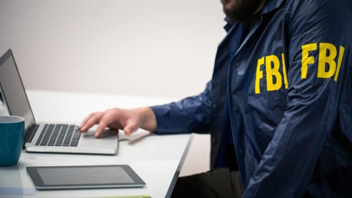 Agente do FBI em computador investigando golpes