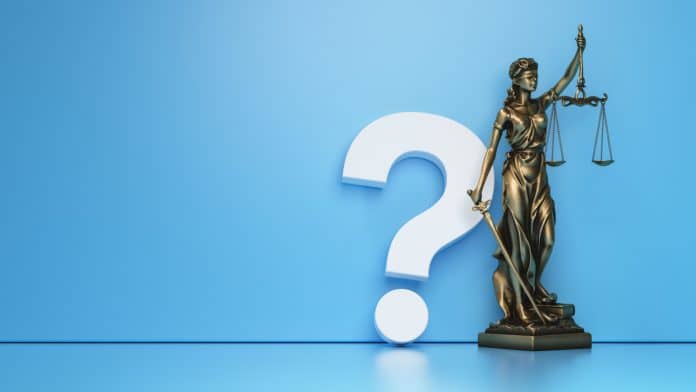 Estátua da justiça com símbolo de interrogação do lado