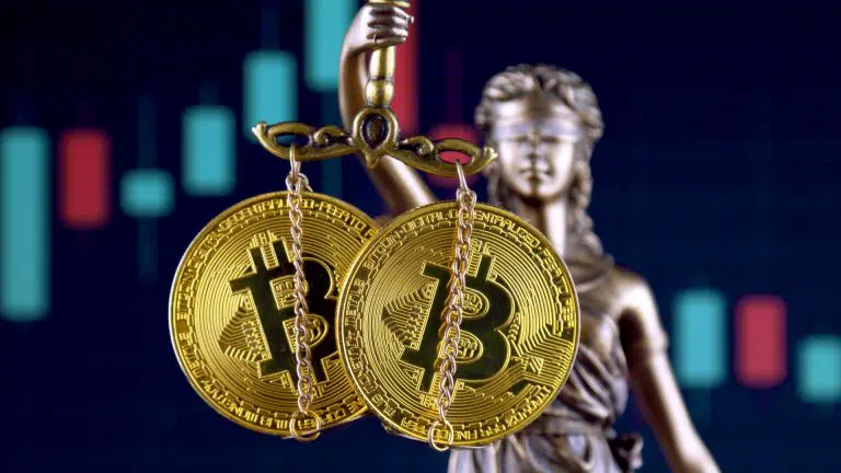 Estátua da justiça segurando Bitcoin e criptomoedas