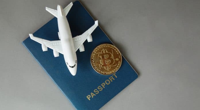 Miniatura de avião, passaporte e Bitcoin