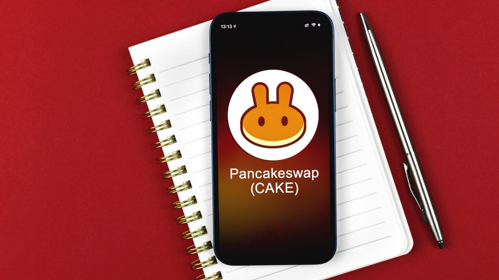 PancakeSwap com caderno de lista com fundo vermelho