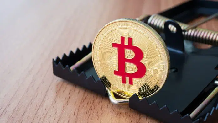 Bitcoin dentro de armadilha, mostrando riscos de investimentos