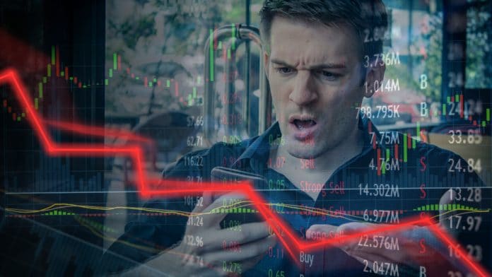 Investidor desapontado com queda em cotação em corretoras, gráficos de preços