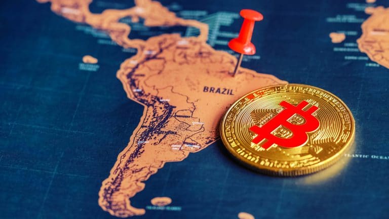 Alfinete vermelho e bitcoin no mapa do Brasil