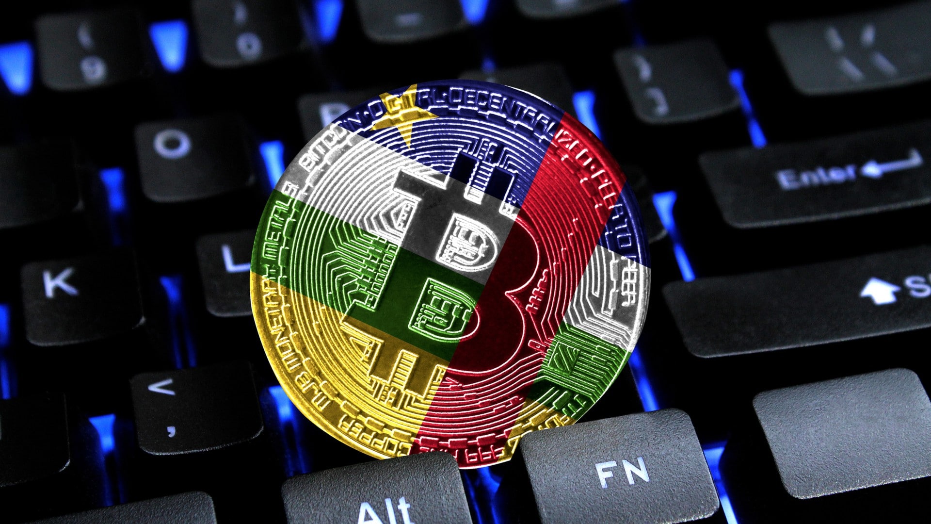 Moeda Bitcoin com bandeira da República Centro-Africana em cima de teclado