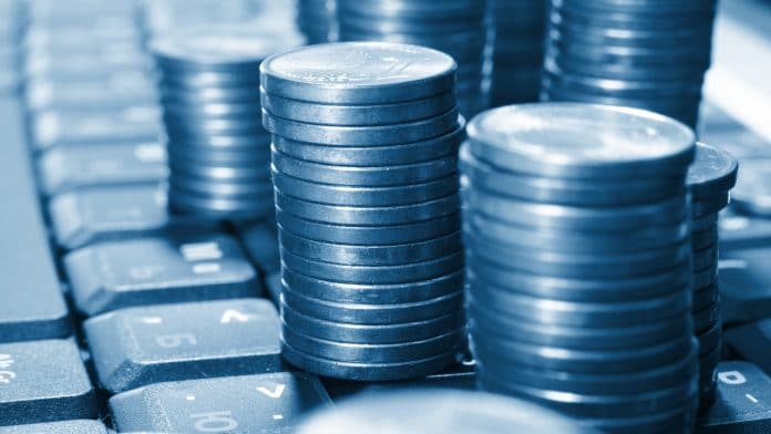 Moedas em cima de teclado, sinônimo de tributação virtual