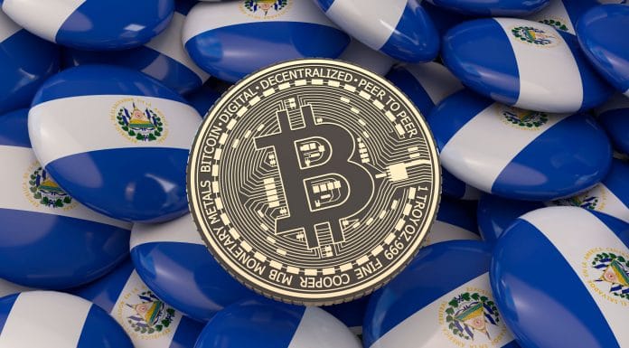 Botões com a bandeira de El Salvador e moeda física de Bitcoin ao centro.
