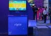 Estande da Ripio no Big Festival 2022, com jogo em televisão indicando vitória