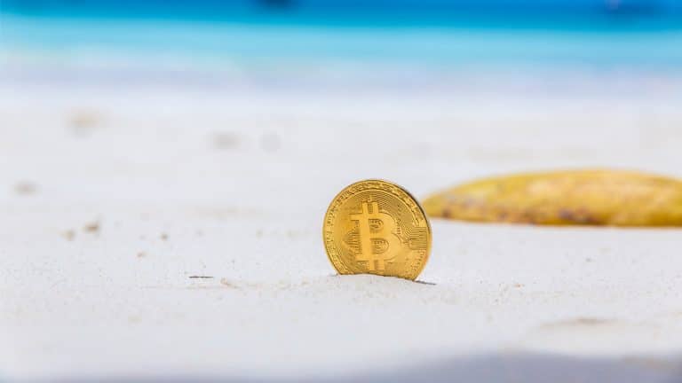 Bitcoin enterrado na areia da praia