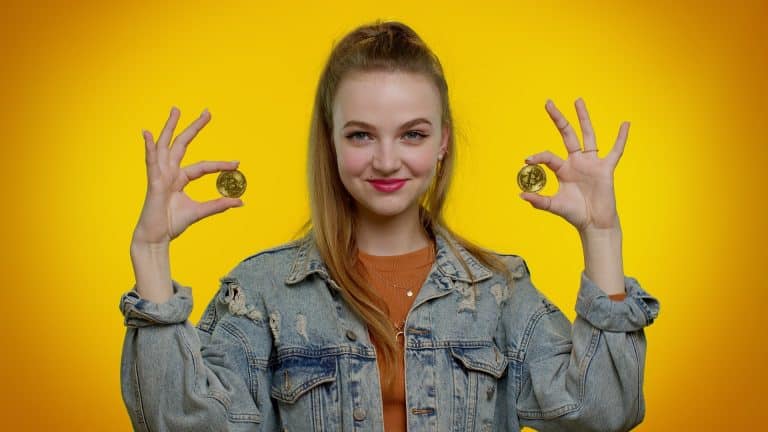 Mulher e Estudante segurando bitcoin e feliz
