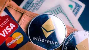 Moeda de Ethereum ao lado de cartões de crédito.