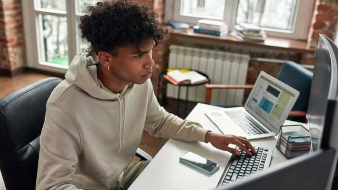 Jovem trabalhando em computador.