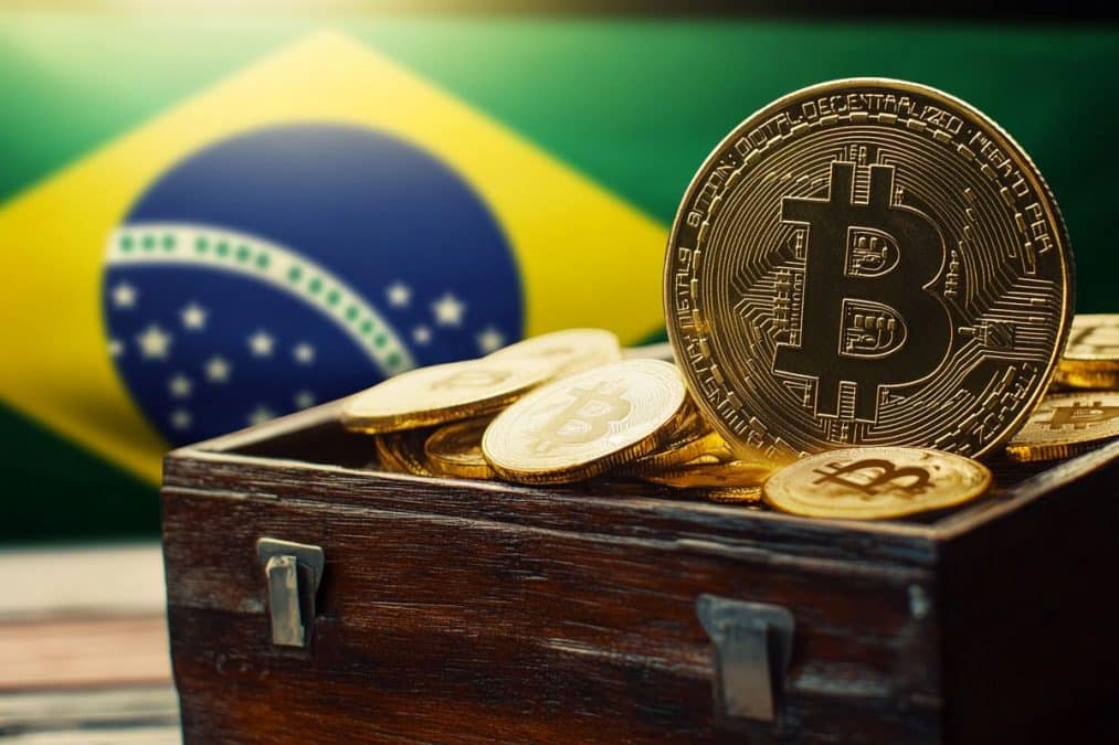 Bitcoin dentro de baú e bandeira do Brasil ao fundo