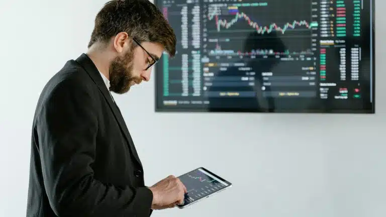 Investidor atento ao dispositivo com preço de criptomoedas
