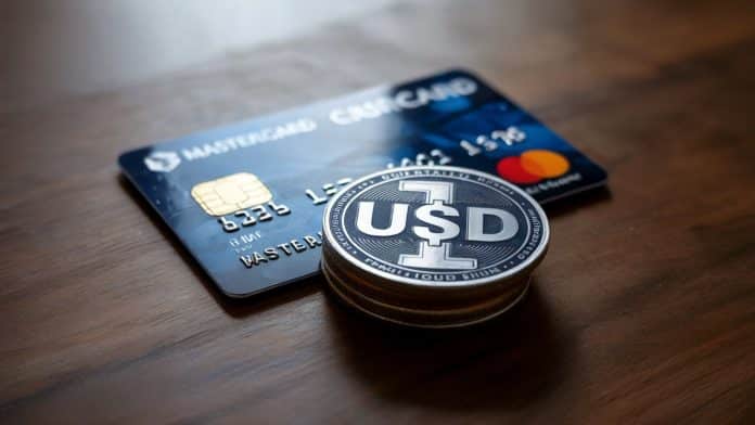 Moeda de um dólar próxima de cartão da MasterCard