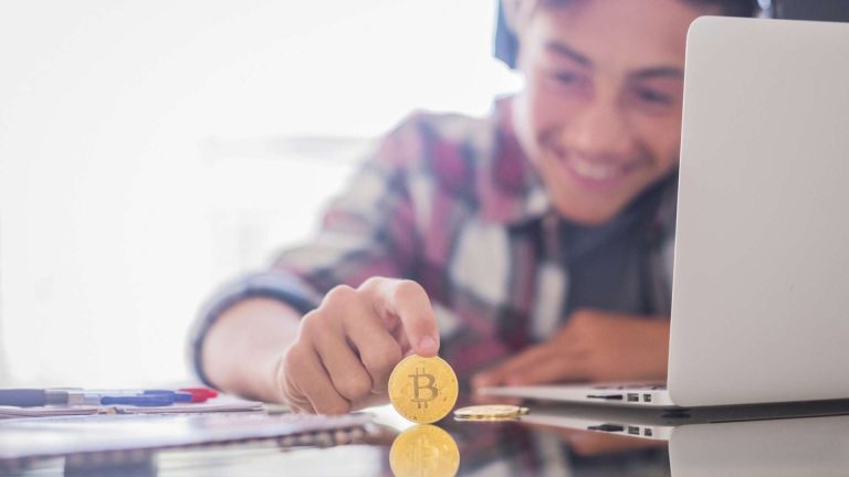 Estudante observando com alegria bitcoin em destaque