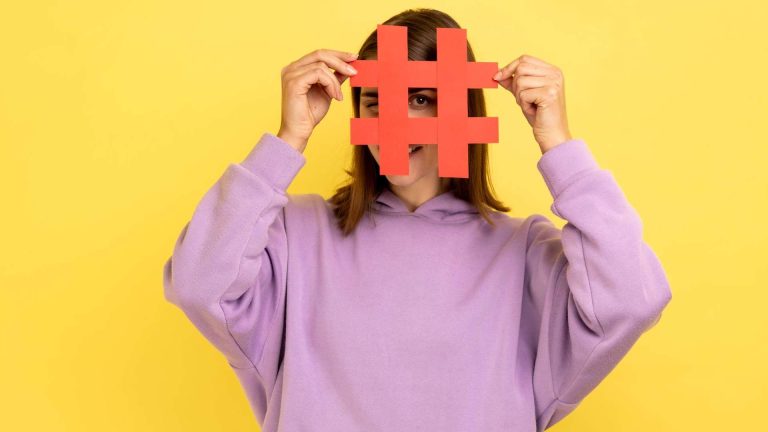 Mulher segurando hashtag em clima de trend nas redes sociais bitcoin Grok inteligência artificial