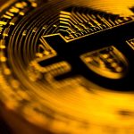 Bitcoin dourado com escrita em preto