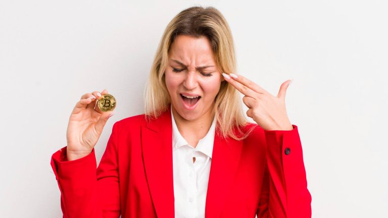 Mulher com bitcoin simbólico na mão e desesperada Contadora é acusada de inventar prejuízos com criptomoedas para fraudar imposto de renda nos EUA